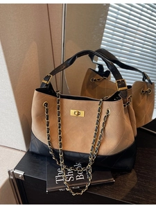 Quilted tote bag in khaki and black with gold chain strap and twist lock closure