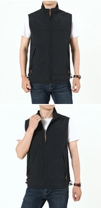 Detail of a black outdoor vest featuring a stand collar and functional zip pockets