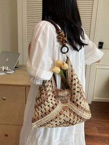 Woven tote bag with wooden beads and tulip decoration in a natural lifestyle setting