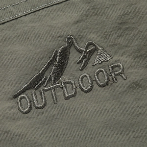 Olive green outdoor vest featuring mountain embroidery and durable textured fabric