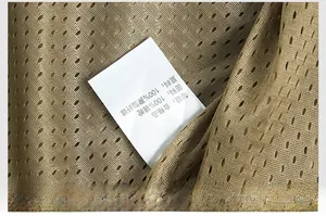 Detail of breathable mesh lining and care label on khaki outdoor fishing vest
