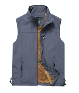 Detail of outdoor utility vest with fleece lining and embroidered mountain chest logo
