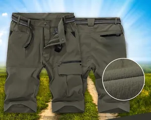 Detail view of army green quick-dry cargo shorts with multi-pockets and woven belt