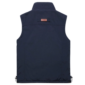 Detail of navy blue vest back featuring leather logo patch and elastic hem drawcord