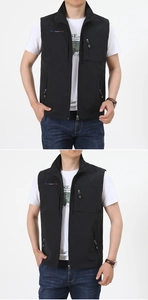 Detail of a black stand-collar utility vest with multiple zipper pockets and logo