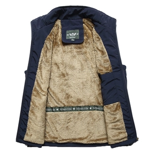 Close-up of men's navy outdoor vest showing warm brown fleece lining and brand label
