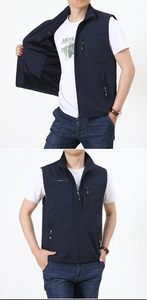 Close-up of deep blue outdoor vest featuring multiple zip pockets and breathable mesh lining