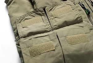 Detail of outdoor tactical vest showing durable fabric with multi-pocket velcro closures