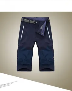 Detail of dark blue quick-dry shorts with gray woven belt and white zipper pockets
