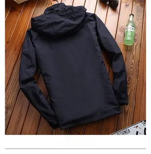 Rückansicht einer leichten Herren-Windjacke mit Kapuze auf rustikalem Holzuntergrund