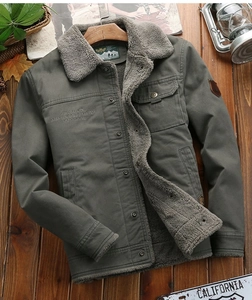 Detail of olive green winter jacket with grey faux shearling lining and metal buttons