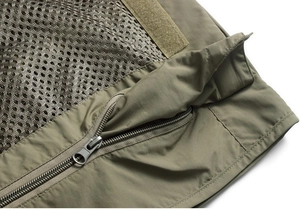 Detail view of durable army green fabric with breathable mesh lining and metal zipper