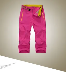 Detail of rose red quick-dry pants featuring contrast yellow waistband and orange zip pocket