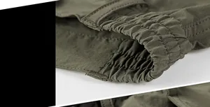 Detailed macro view of the elastic waistband on army green quick-dry outdoor shorts