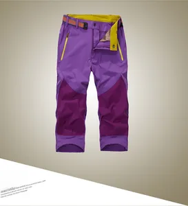 Detail of purple quick-dry shorts with orange belt and yellow contrast zipper accents