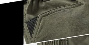 Detail of army green quick-dry shorts featuring side pocket design and reinforced stitching