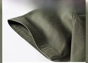 Macro shot of durable double-stitched cuff design on army green twill cotton shirt