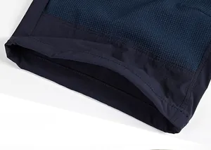 Detail view of navy blue waffle knit fabric and reinforced hem stitching on pants