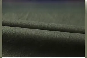 Macro view of olive green twill fabric showing detailed weave and brushed matte texture