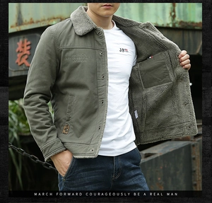 Detail of army green cargo jacket with thick grey fleece lining and chest embroidery