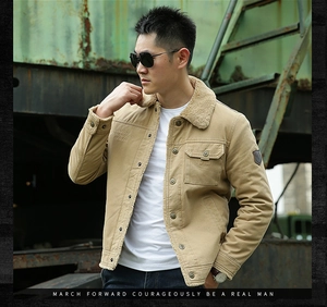 Close-up of khaki canvas jacket featuring a plush beige faux fur collar and leather arm badge