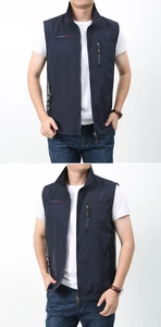 Detail of navy blue vest featuring a chest zipper pocket and breathable mesh side panels