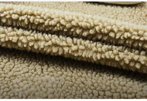 Detail shot of soft beige lamb velvet fabric showing thick fleece texture and warmth