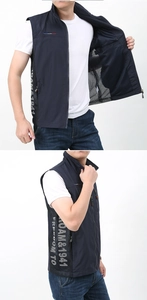Detail of navy blue outdoor vest featuring breathable black mesh side panels and white prints