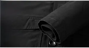 Detailed macro view of the black jacket sleeve cuff with textured button and twill fabric