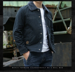 Detail of navy blue fleece-lined outdoor jacket with gray collar and embroidery