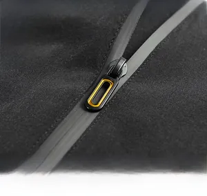 Macro detail of high-quality black metal zipper with yellow ring on windproof jacket