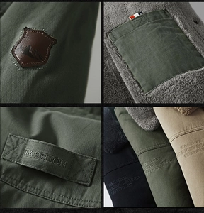 Detail of fleece lining and embroidered patches on heavy outdoor cotton jacket for men