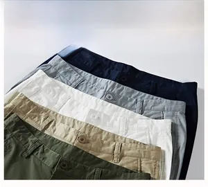 Five assorted colors of men's casual cotton twill shorts stacked in a row