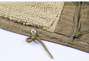 Detail of warm khaki jacket with fleece lining, sturdy metal zipper and waist drawstring