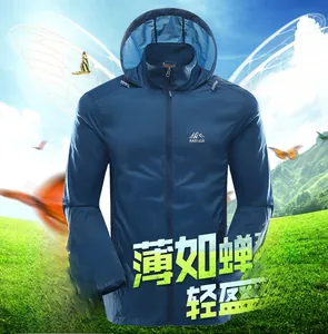 Detail of dark blue lightweight sun protection hoodie with mountain logo on grass background