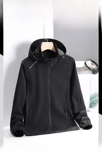 Detail of a black hooded windbreaker jacket with sports logo and elastic cuffs