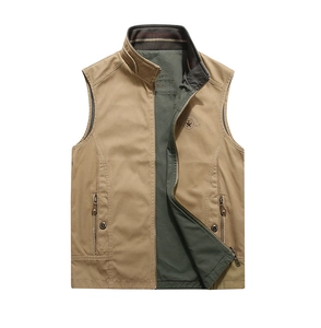Detail of embroidered logo on a khaki reversible outdoor vest with a stand collar and zipper