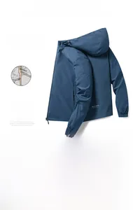 Detail view of the 3D ergonomic tailoring and elastic cuffs on a blue hooded sports jacket