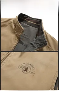 Detailed close-up of khaki outdoor vest showing stand collar and vintage embroidery