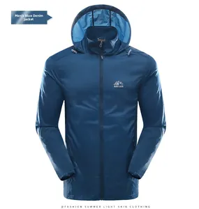 Detail of denim blue sun protection jacket with hood and mountain chest logo