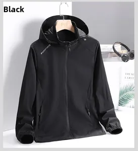 Detail of black hooded windbreaker with zip pockets and elastic cuffs for outdoor use
