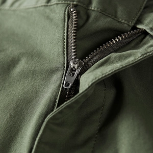 Army green casual shorts featuring a durable bronze metal zipper and cotton twill fabric