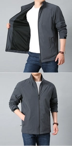 Detail view of men's grey windproof jacket showing mesh lining and stand collar