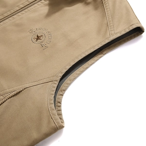 Men's khaki reversible fishing vest featuring detailed star embroidery and metal zipper