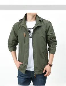 Detail of army green outdoor hooded jacket featuring chest zipper pocket and mountain logo