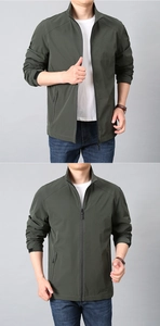 Detail of dark green windbreaker featuring stand collar, zipper closure and adjustable cuffs