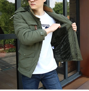 Detail view of the plush fleece lining and military green fabric of men's winter parka