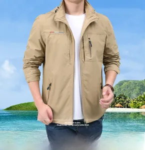 Close-up of khaki waterproof jacket with zipper pockets and Follow Dreams lettering