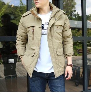 Detail of khaki outdoor jacket featuring ROUG STOCK embroidery and metal snap buttons