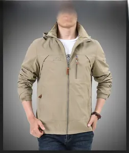 Detail of khaki outdoor hooded jacket showing zipper pockets and embroidered logo